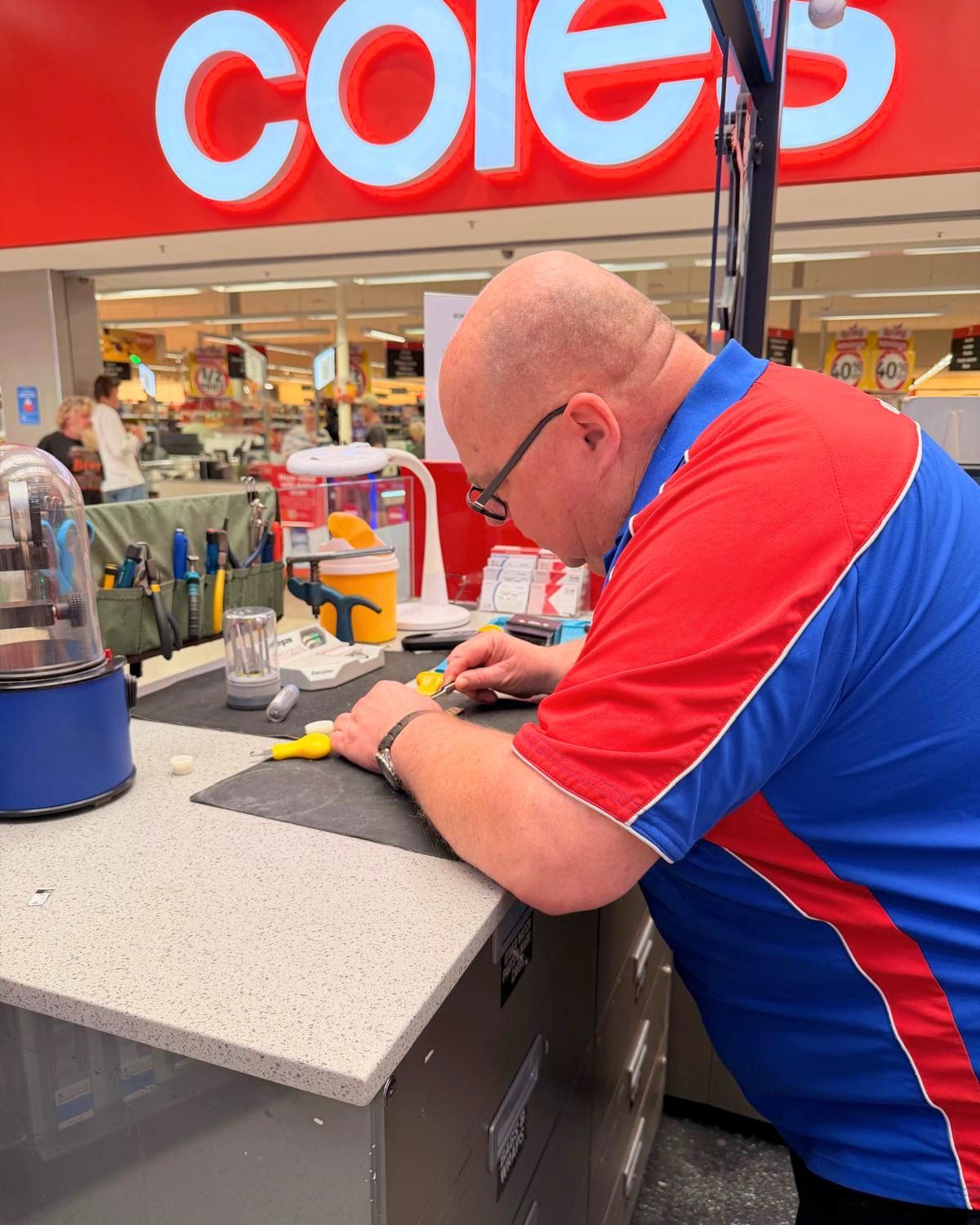 John completing a repair at Mister Minit Wallsend