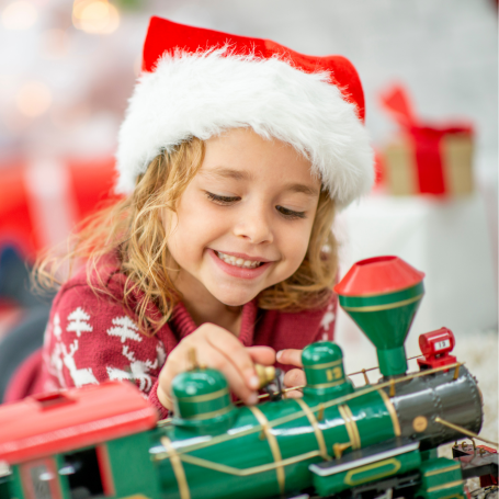 Kid playing with a Christmas train