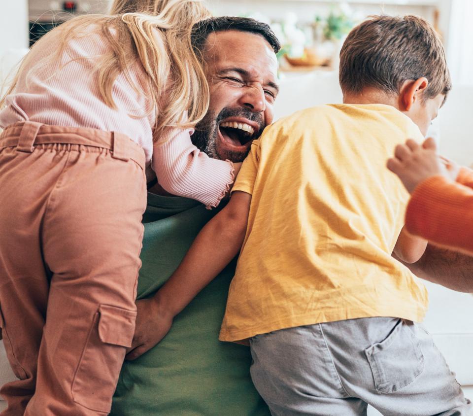 Dad playing with his kids.